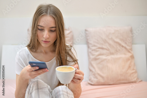 Girl With Cup Of Coffee In Bedroom