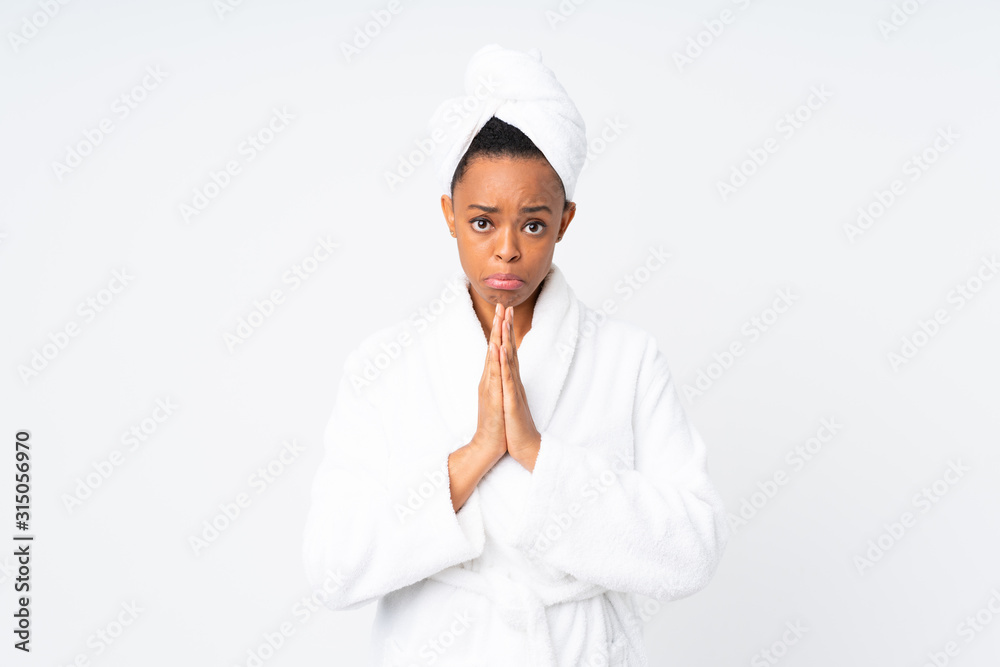 African american woman in a bathrobe over isolated background pleading African american woman in a bathrobe over isolated background pleading