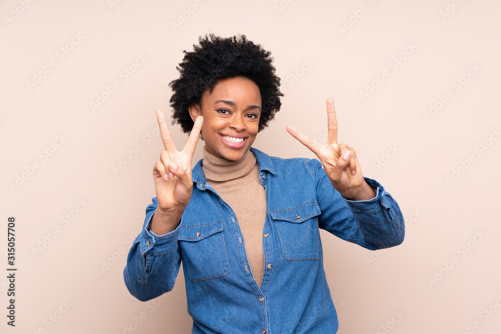 African american woman over isolated background smiling and showing victory sign African american woman over isolated background smiling and showing victory sign