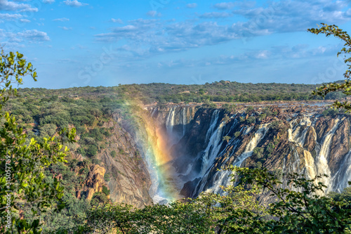 rainbow over landscape of Ruacana Falls on the Kunene River in Northern Namibia and Southern Angola border, Africa wilderness landscape