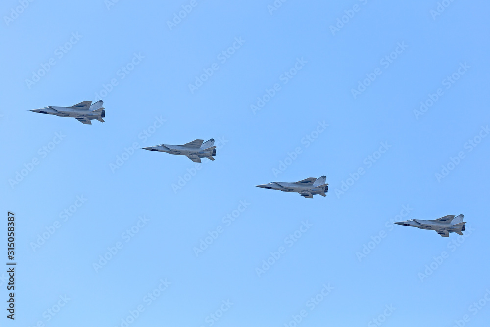 Russian Military jet in the air. Silhouettes of russian fighter aircrafts in the sky. military aircrafts flying together in the sky during airshow Russian Military jet in the air. Silhouettes of russian fighter aircrafts in the sky. military aircrafts flying together in the sky during airshow