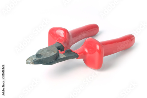 Metall wire cutters with red rubber handles isolated on white background.