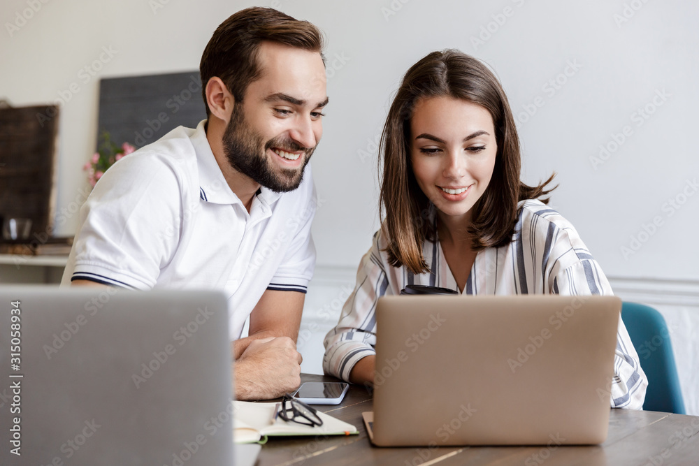 Smiling young couple working on a project Smiling young couple working on a project