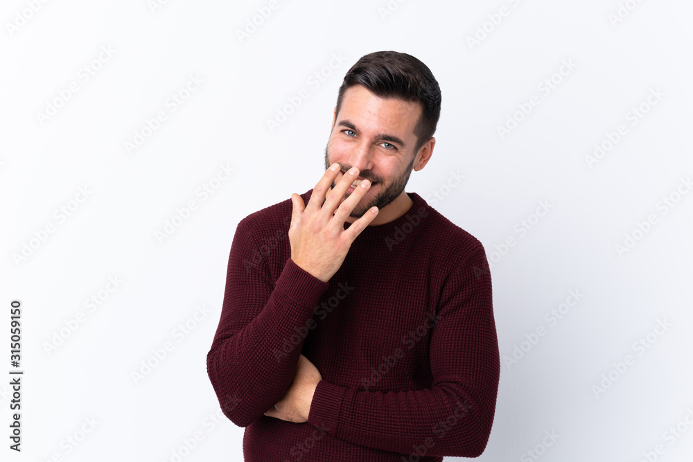 Young handsome man with beard over isolated white background smiling a lot