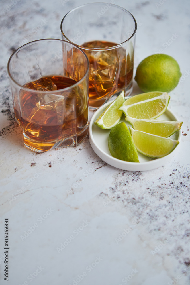 Whiskey sour drink with lemon in glass on stone rustical background