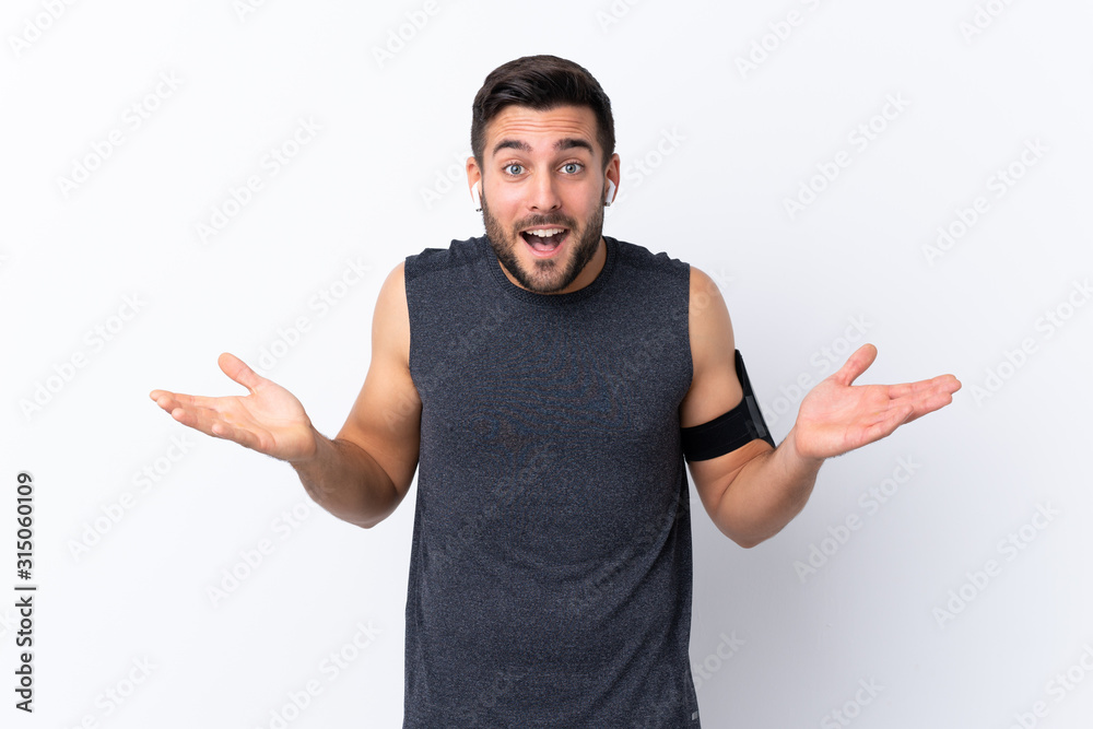 Fototapeta premium Young sport handsome man with beard over isolated white background with shocked facial expression