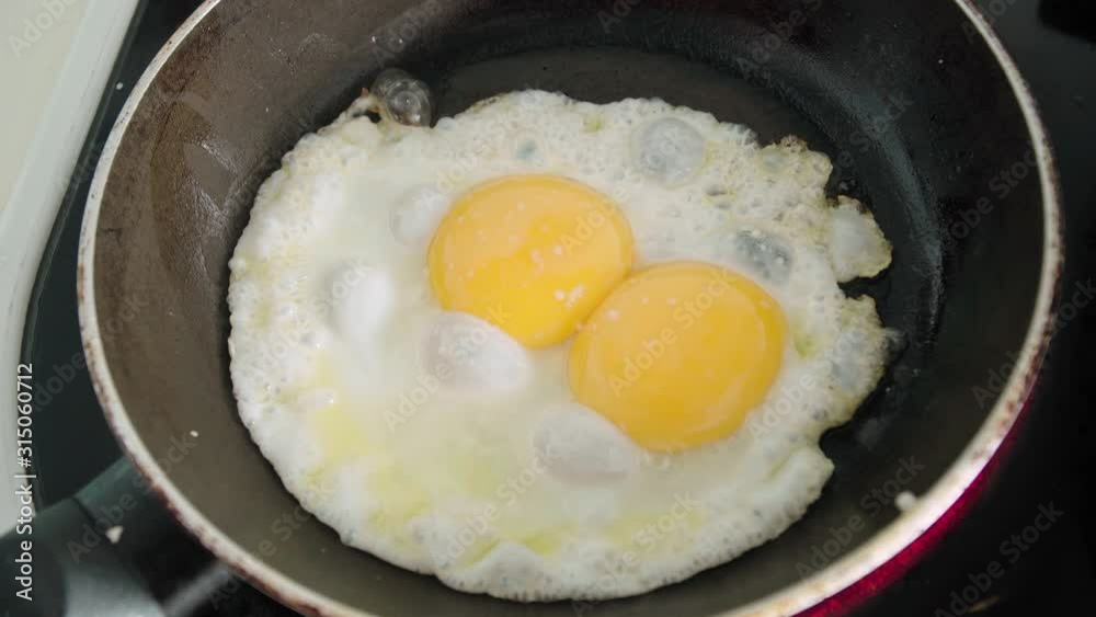 Egg with double yolk in frying pan sunny side up, Close Up Detail Shot Egg with double yolk in frying pan sunny side up, Close Up Detail Shot