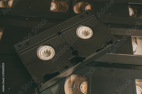 Old VHS videocassette tapes as background. Retro technology.