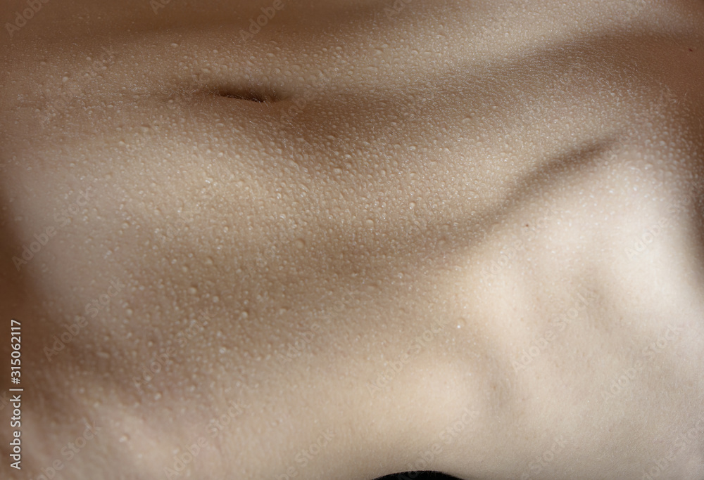 Fototapeta premium Naked belly with water drops.