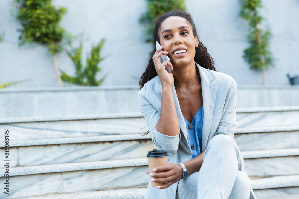Beauituful smiling young african business woman sitting