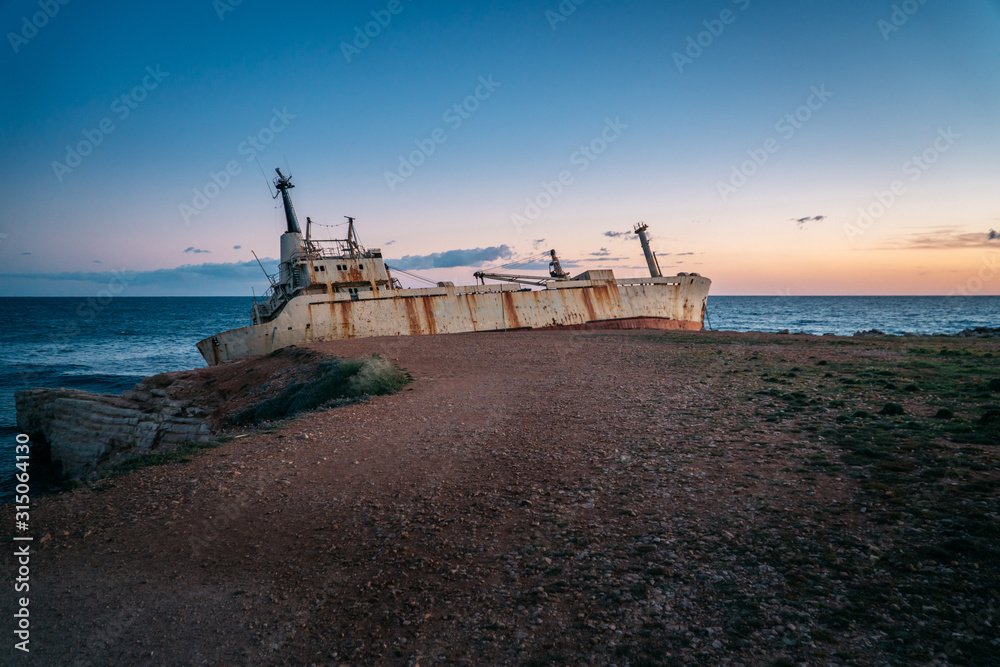 An old ship stranded stands on the seashore. An old ship stranded stands on the seashore.