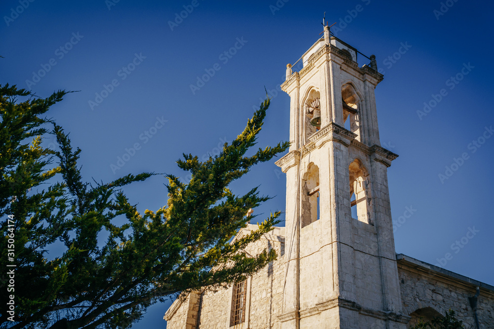 The bell tower of the old church against the sky.