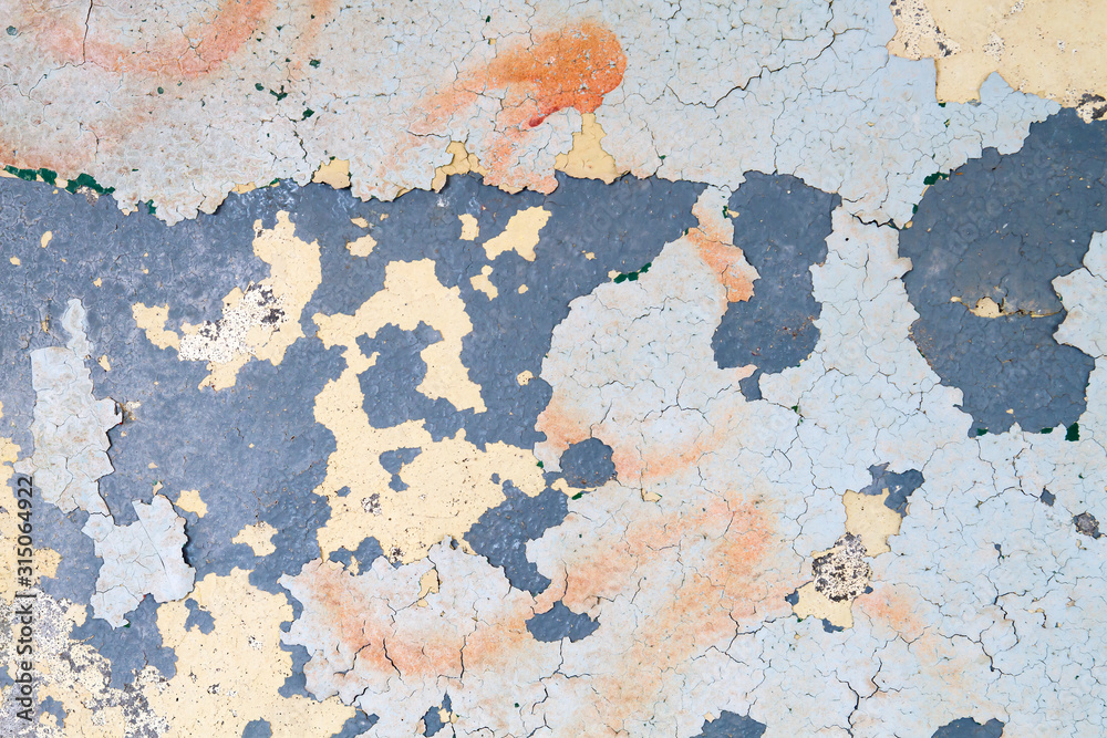 Layers of peeling paint on old wall