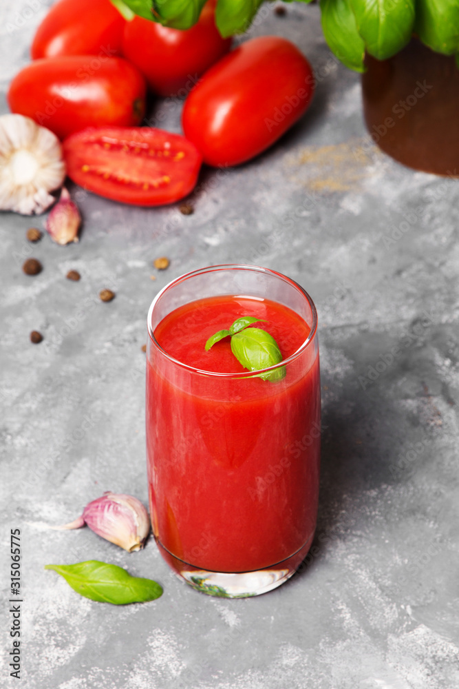 Tasty tomato juice with fresh spices, garlic, pepper and basil