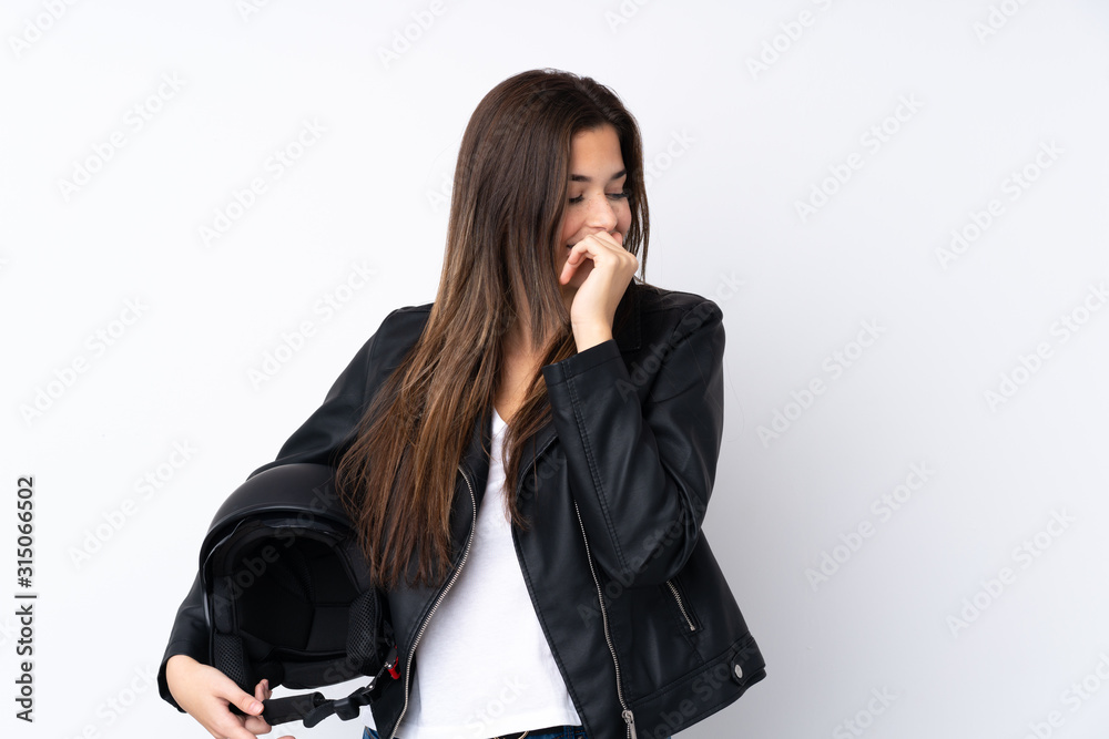 Young woman with a motorcycle helmet over isolated white background laughing Young woman with a motorcycle helmet over isolated white background laughing