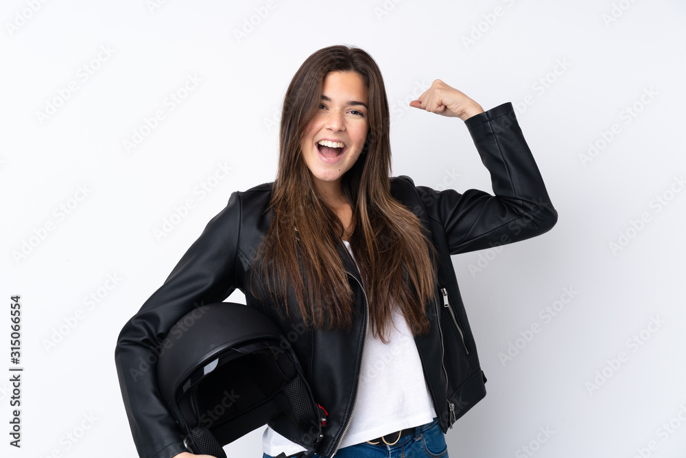 Young woman with a motorcycle helmet over isolated white background celebrating a victory Young woman with a motorcycle helmet over isolated white background celebrating a victory
