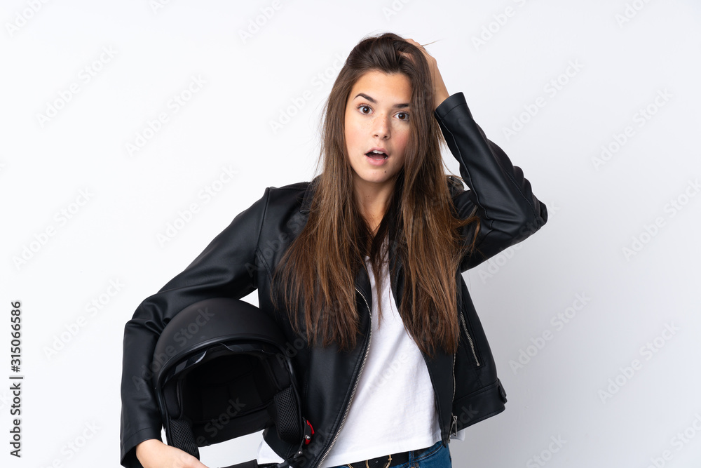 Young woman with a motorcycle helmet over isolated white background with surprise facial expression Young woman with a motorcycle helmet over isolated white background with surprise facial expression
