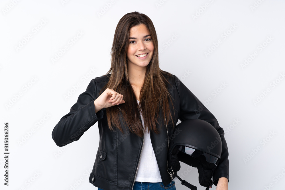 Young woman with a motorcycle helmet over isolated white background proud and self-satisfied Young woman with a motorcycle helmet over isolated white background proud and self-satisfied