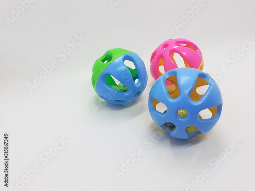 Various Colorful Cute Plastic Balls Design with Bells Ringer Sound Inside for Children or Pet Toys and Educational Purpose in White Isolated Background