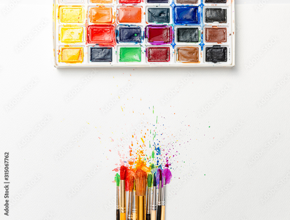 watercolor brushes on white paper