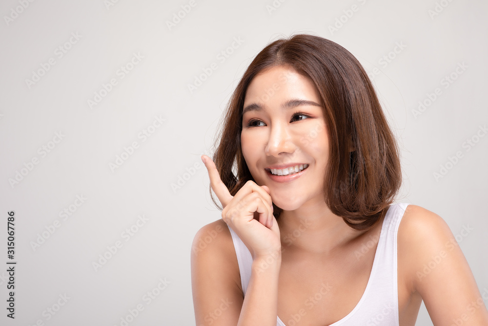 Beautiful Asian woman with short hair looking at camera smile with clean and fresh skin Happiness and cheerful with positive emotional,isolated on gray background,Beauty and Cosmetics Concept Beautiful Asian woman with short hair looking at camera smile with clean and fresh skin Happiness and cheerful with positive emotional,isolated on gray background,Beauty and Cosmetics Concept