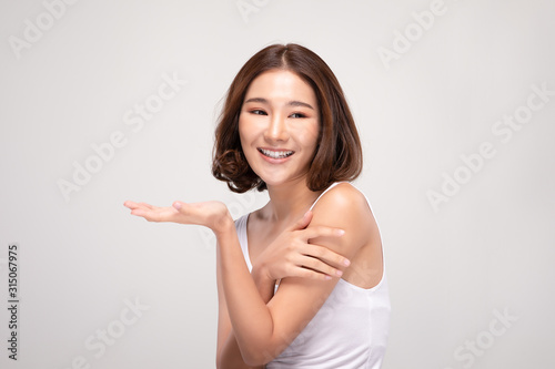 Beautiful Attractive Charming Asian young woman smile with white teeth open hand palm for display cosmetics product cheerful with healthy skin,isolated on white background,Beauty Cosmetics Concept