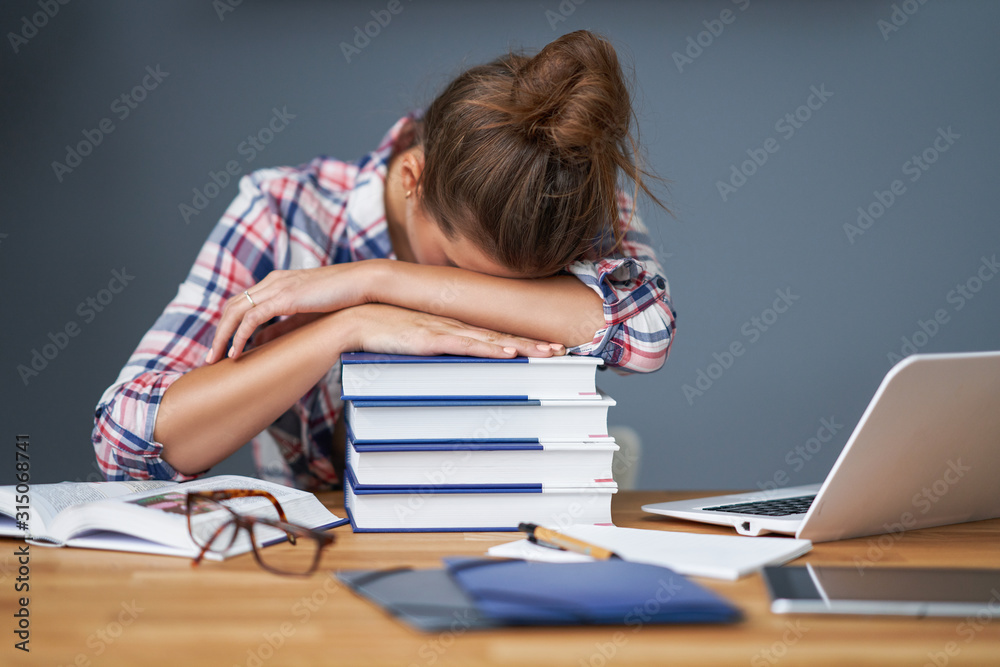Tired female student learning till late at home Tired female student learning till late at home