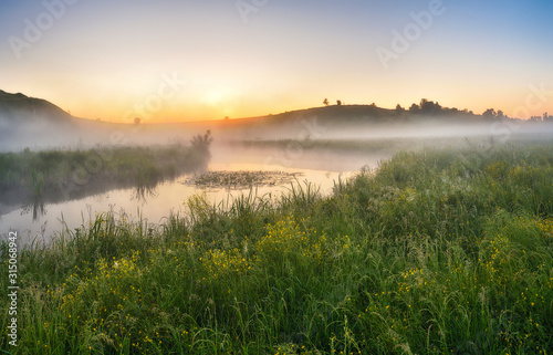 foggy morning. Dawn in the valley of a picturesque river. spring morning
