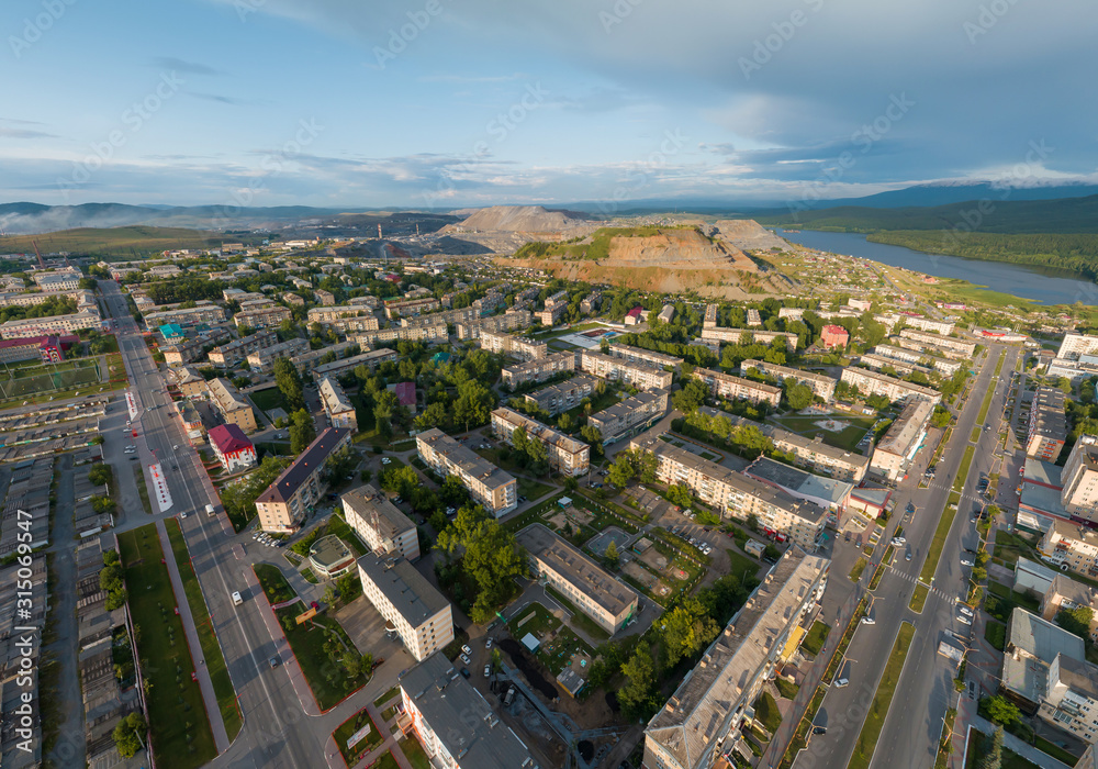 Aerial view of Satka city. Far away Karagai quarry and pond. Chellyabinsk region, Russia. Summer, sunny