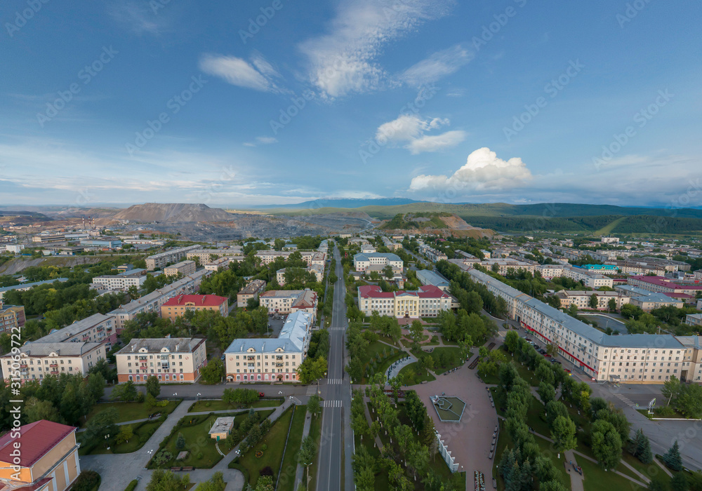 Satka city. Square. Far away Karagai quarry. Chelyabinsk region, Russia. Aerial, summer, evening