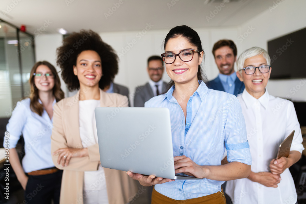 Successful team of young perspective businesspeople in office Successful team of young perspective businesspeople in office
