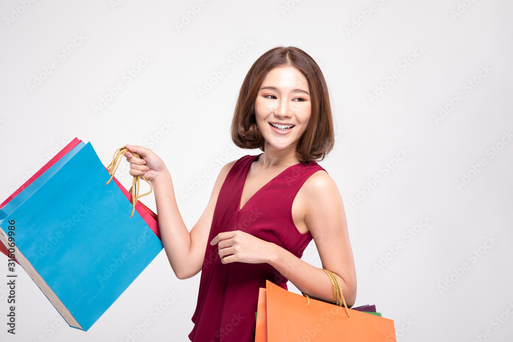 Shopping Asian woman with short hairs smile wearing red dress Holding  Shopping bags,Cheerful and happiness emotional,Enjoy Shopping in black  friday sale,Isolated on gray background,Shopping Concept Stock-Foto | Adobe  Stock