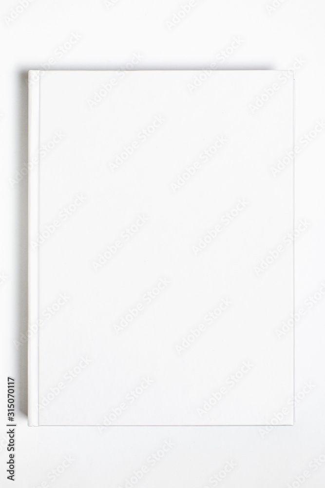 Mockup of closed blank square book at white textured paper background