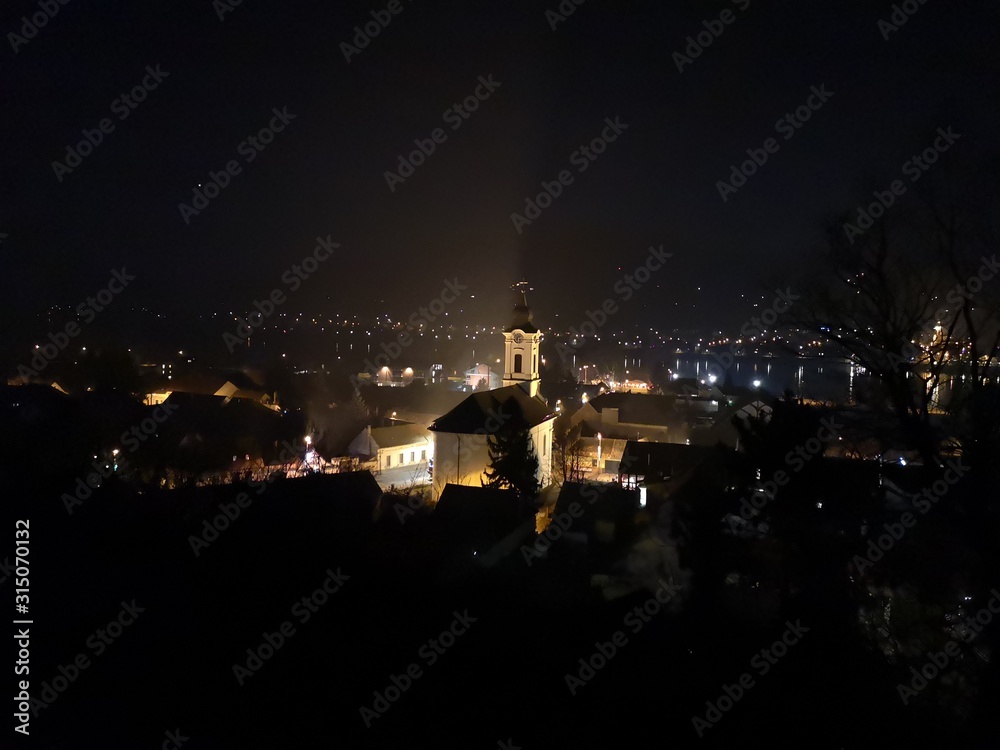 Night view of the city of Visegrad from the hilltop, with the light up church in the middle