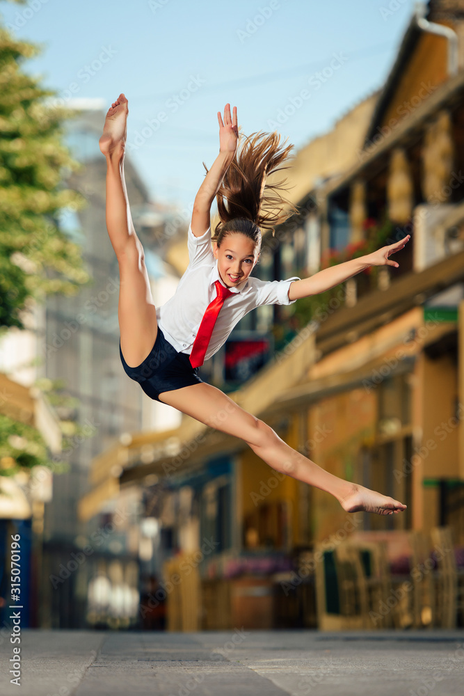 Fototapeta premium Dancing in the Street. Young Teenage Jazz Dancer Performing on the Street