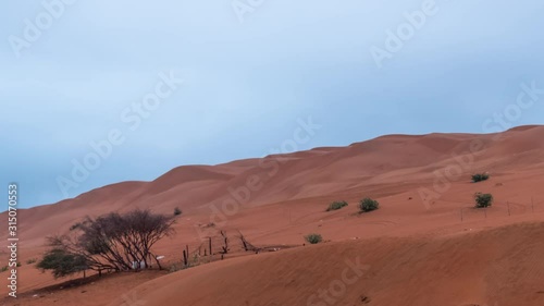 Wahiba Sands Desert in Oman at Sunrise Timelapse also known as Sharqiya Sands or Ramlat al-Wahiba photo