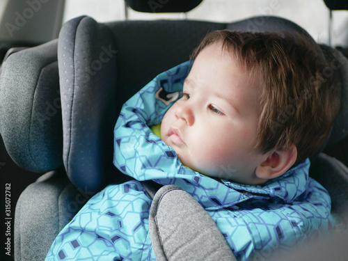 child in a car seat. Child safety in the childs car seat during sleep.
