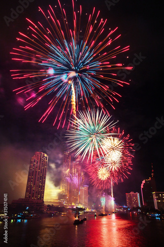 BANGKOK, THAILAND - 2020 JANUARY 1: New year countdown celebration fireworks along Chaophraya river, view from Taksin bridge in Bangkok, Thailand.