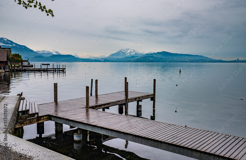 Landscape view of Lake Zug with wooden pier, Switzerland