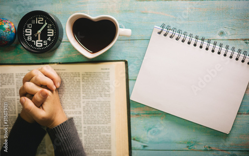 Hands woman pray on open bible,prayer and worship in the morning with copy space.