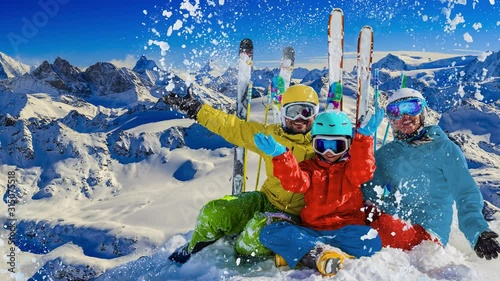 Happy family enjoying winter vacations in mountains . Ski, Sun, Snow and fun.