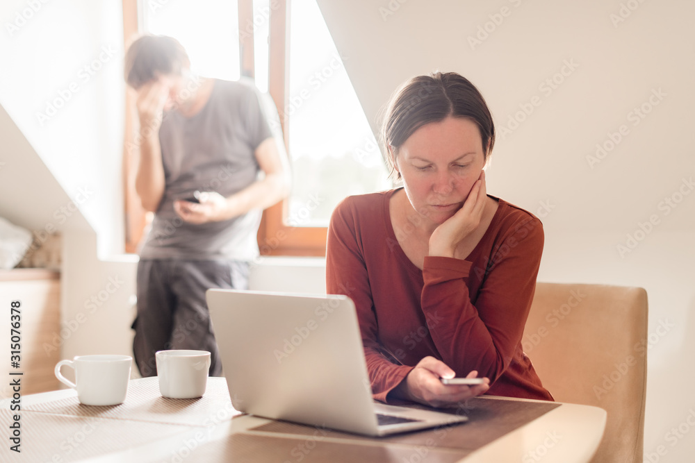 Couple telecommuting, woman and man working in home office Couple telecommuting, woman and man working in home office