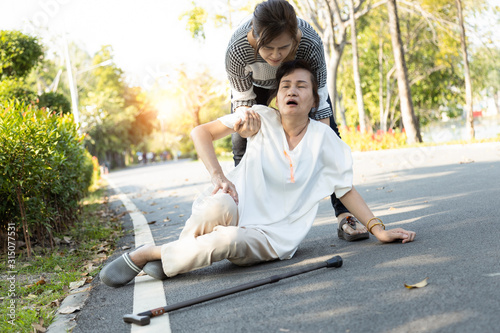 Tired senior woman or mother suffer from sunburn very hot,feeling faint,dizzy,daughter assisting,support her in outdoor at park,female elderly with syncope,unconscious or heat stroke,,fatigue photo