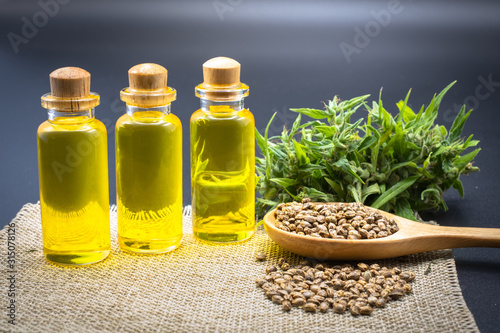 Hemp oil products in small bottles placed together.Hemp oil, CBD extracted from fresh hemp extract.Green marijuana background. There is space for entering text.