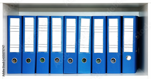 Bild auf Leinwand Blue file folders or binders in a row on the office shelf