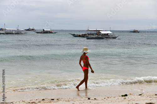 girl walks along the beach along the sea on a tropical island in the philippines