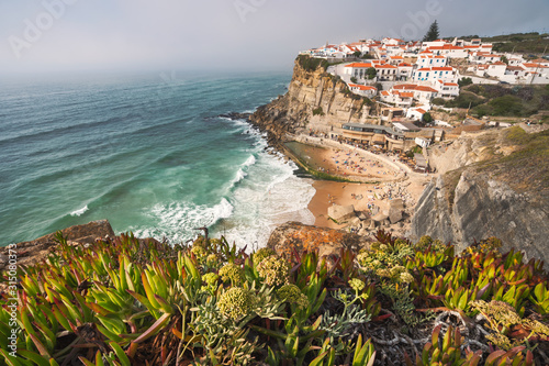 Sintra, Lisbon, Portugal. Azenhas do Mar white village landmark on the cliff and Atlantic ocean waves photo