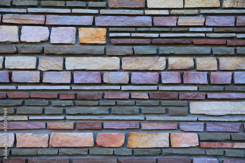 Wallpaper Mural Multy-colored (colorful) decorative stone wall, texture, background. Varicolored flat stones of regular shape in the wall construction. Decorative stone laying. The design of stylish exterior Torontodigital.ca