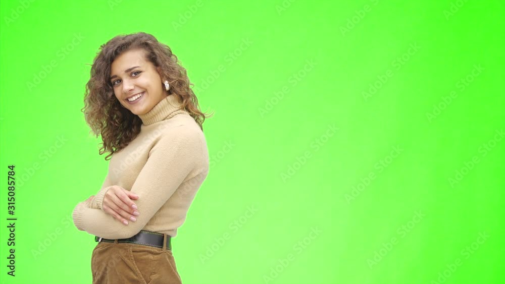 Attractive afro-american girl is smiling widely. Side view. Girl with her arms crossed. Close up. Copy space. Attractive afro-american girl is smiling widely. Side view. Girl with her arms crossed. Close up. Copy space.
