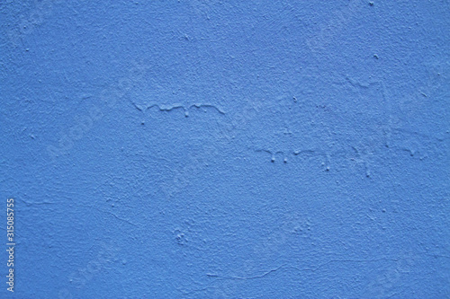 Blue abstract background..Beautiful blue textured plaster on the wall..Background from blue stucco..